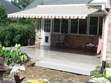 striped canvas patio cover with creole valance on a garden district home